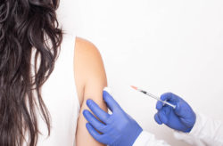 Stock photo of a woman obtaining a shot from her medical provider