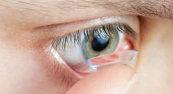 Stock photo of a person putting in a contact lens