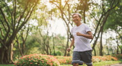 Stock photo of a middle-aged man running on a path outside
