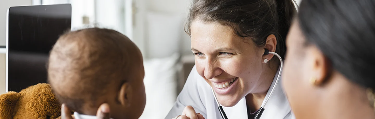 Doctor Examining a Young Boy with his Mom